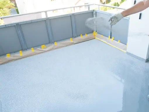 applying flakes into an epoxy flooring in a terrace